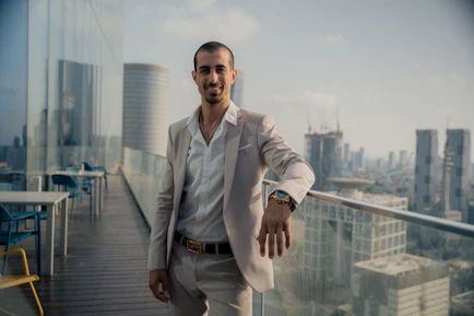 A confident financial advisor discussing plans with clients in a modern office overlooking a global cityscape.