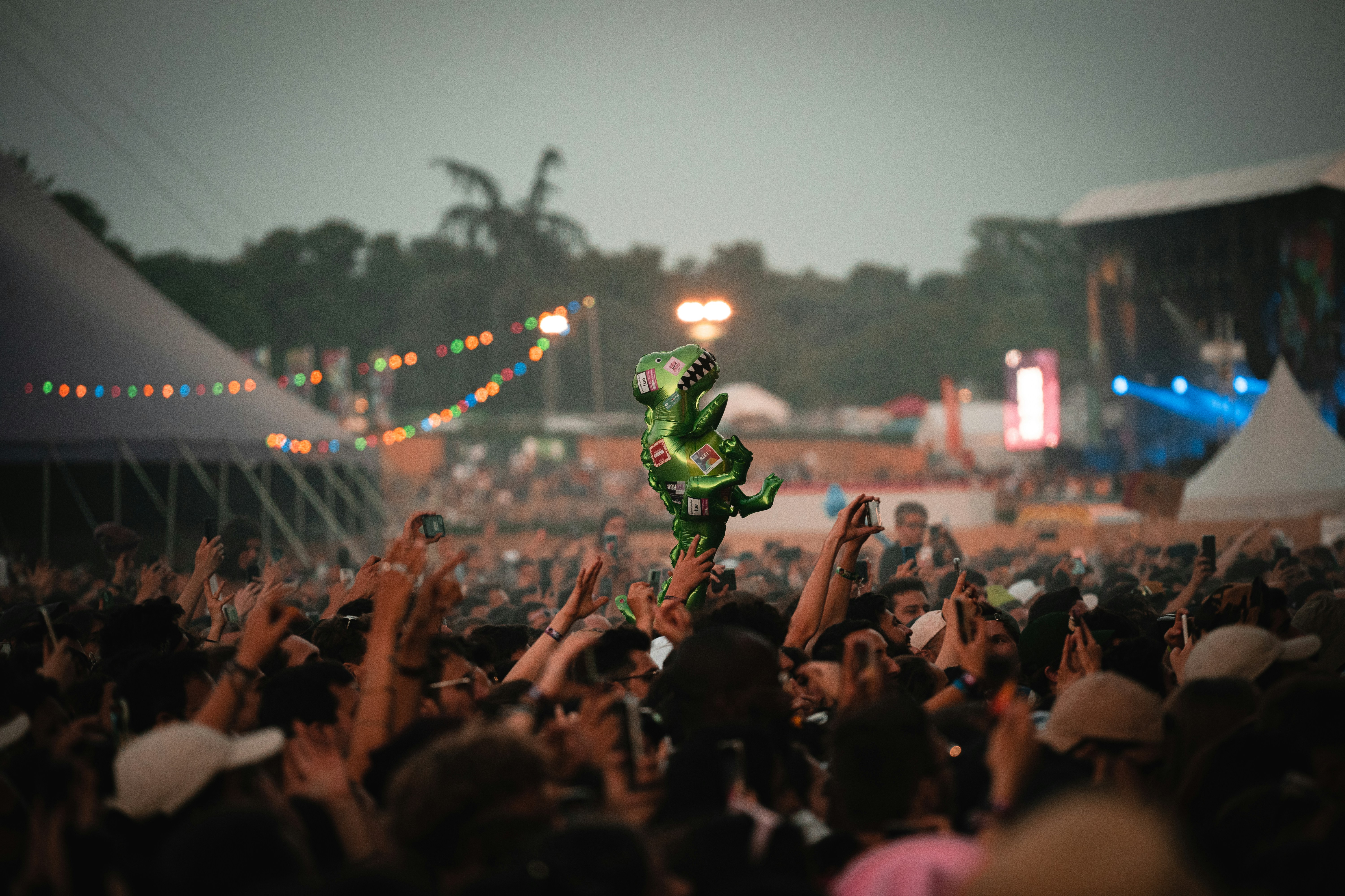 a person on a stage with a crowd watching