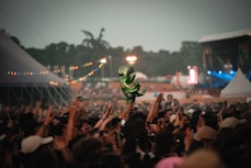 a person on a stage with a crowd watching
