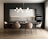 A modern kitchen and dining area with a sleek design. The space features a dark grey cabinet wall, white upper cabinets, and a marble backsplash. A large dining table is surrounded by six beige upholstered chairs with black metal legs. Above the table hangs a contemporary chandelier made of spherical lights. The flooring is a light wood, contributing to a warm and inviting atmosphere.