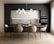 A modern kitchen and dining area with a sleek design. The space features a dark grey cabinet wall, white upper cabinets, and a marble backsplash. A large dining table is surrounded by six beige upholstered chairs with black metal legs. Above the table hangs a contemporary chandelier made of spherical lights. The flooring is a light wood, contributing to a warm and inviting atmosphere.