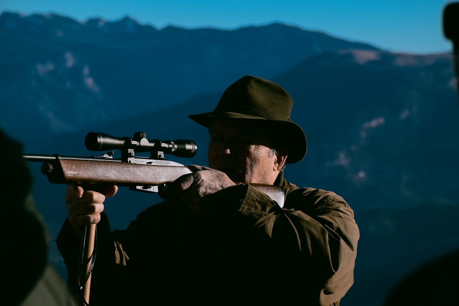 Hunter hiking deep into a remote mountain basin on public land far from any road
