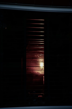 Soft natural light filtered through the edges of blackout shades, highlighting their thickness.