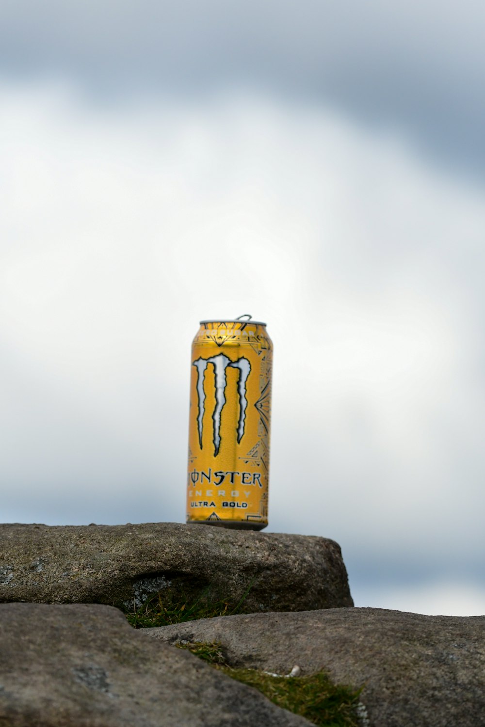 a yellow sign on a rock