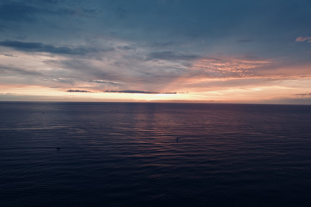 a body of water with a sunset