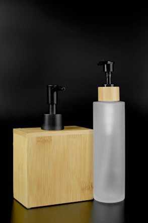 a white cylindrical object with a black top and a black top