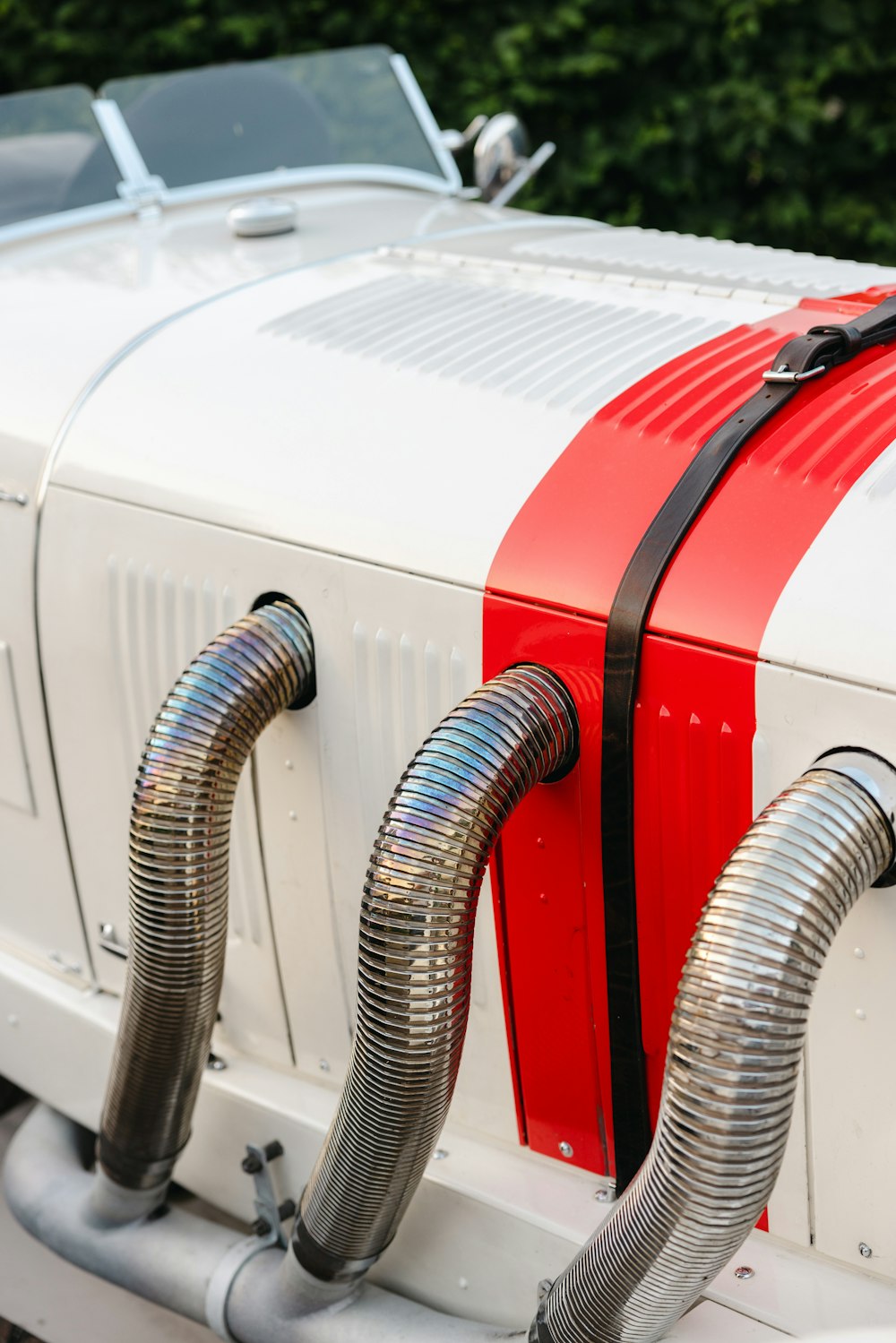 a white car with a red and silver stripe