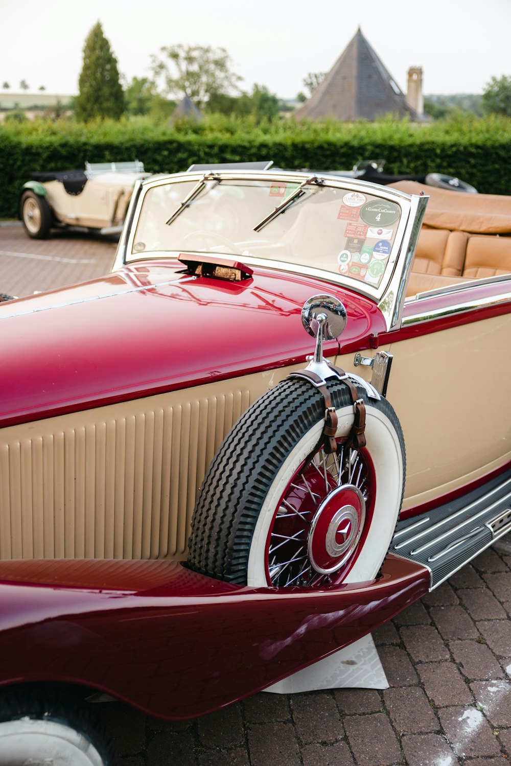 a red car parked on a brick road