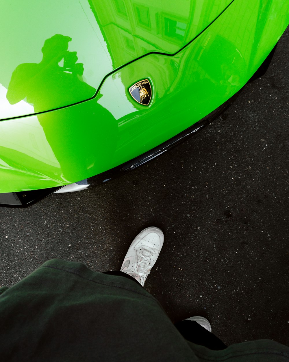 a person's feet on a green and black object