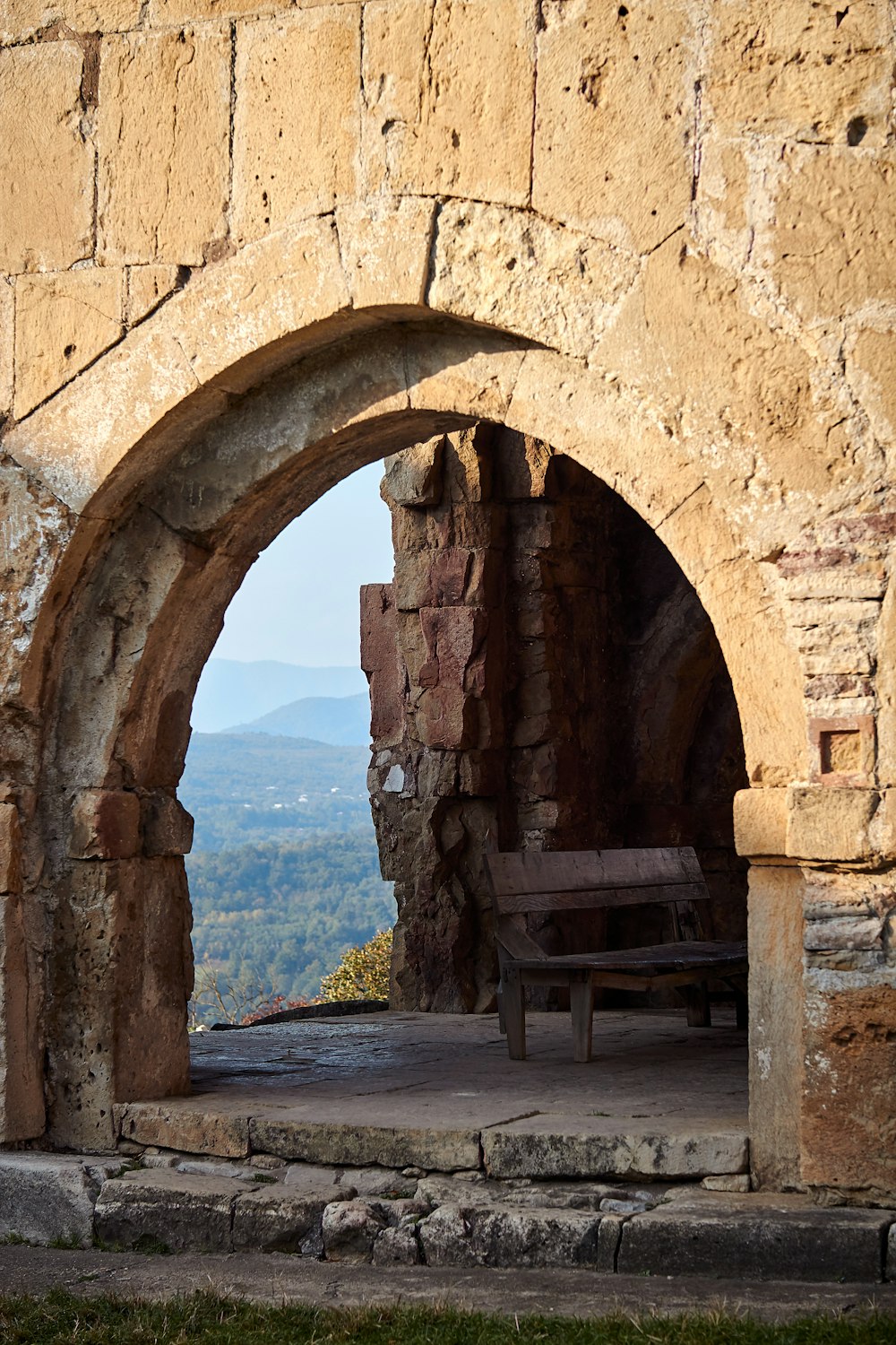 a bench in a stone tunnel