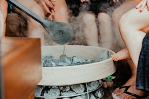 a person pouring water into a glass