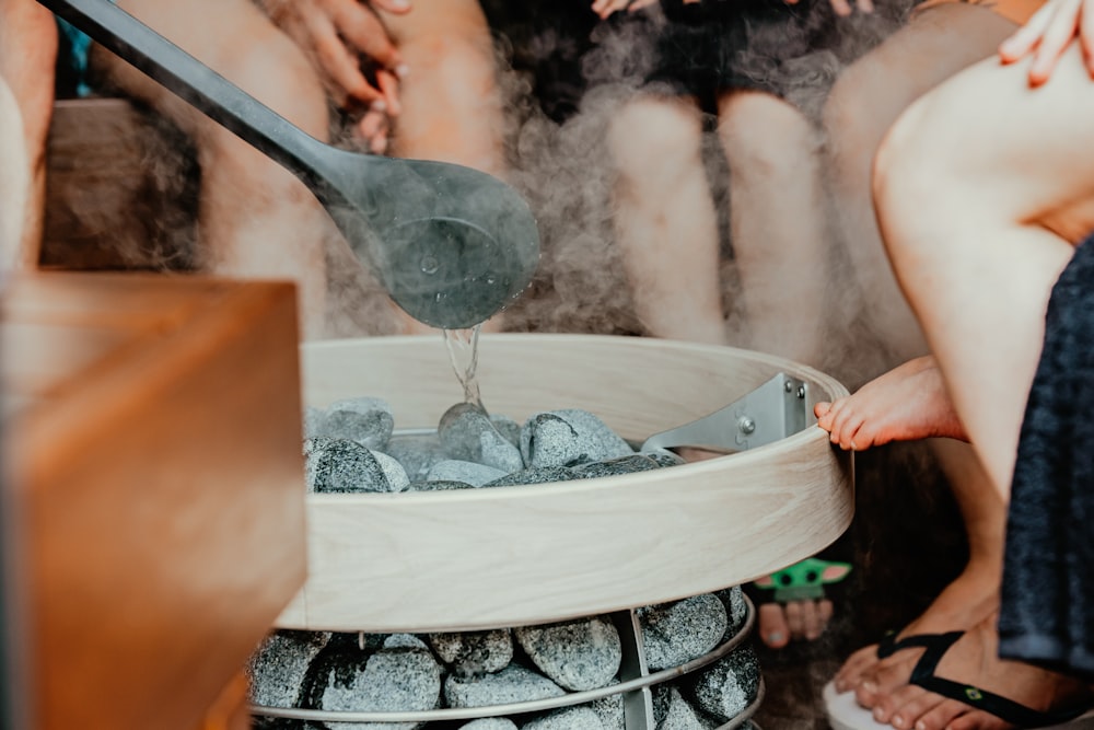 a person pouring water into a glass