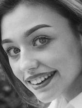 A professional photographer taking portraits of a smiling healthcare professional in a clinic.
