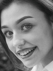 A professional photographer taking portraits of a smiling healthcare professional in a clinic.