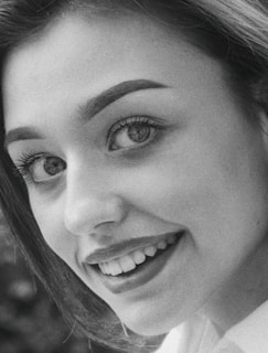 Close-up of a man smiling casually, showcasing refined photo retouching and clear details.