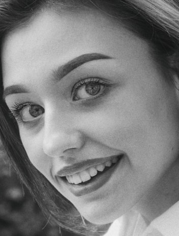 Close-up of a man smiling casually, showcasing refined photo retouching and clear details.