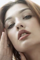 a woman with her hand on her face
