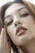 a woman with her hand on her face