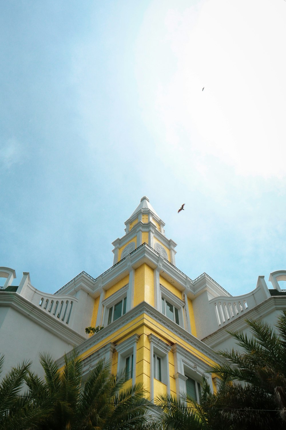 a bird flying over a building