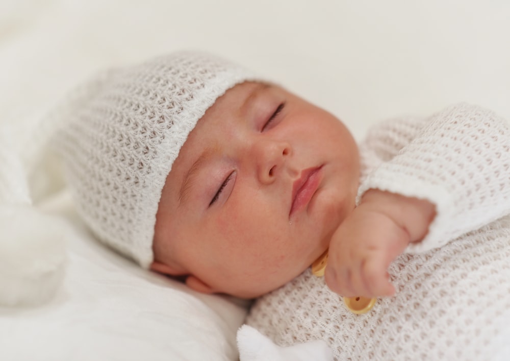 a baby sleeping on a blanket