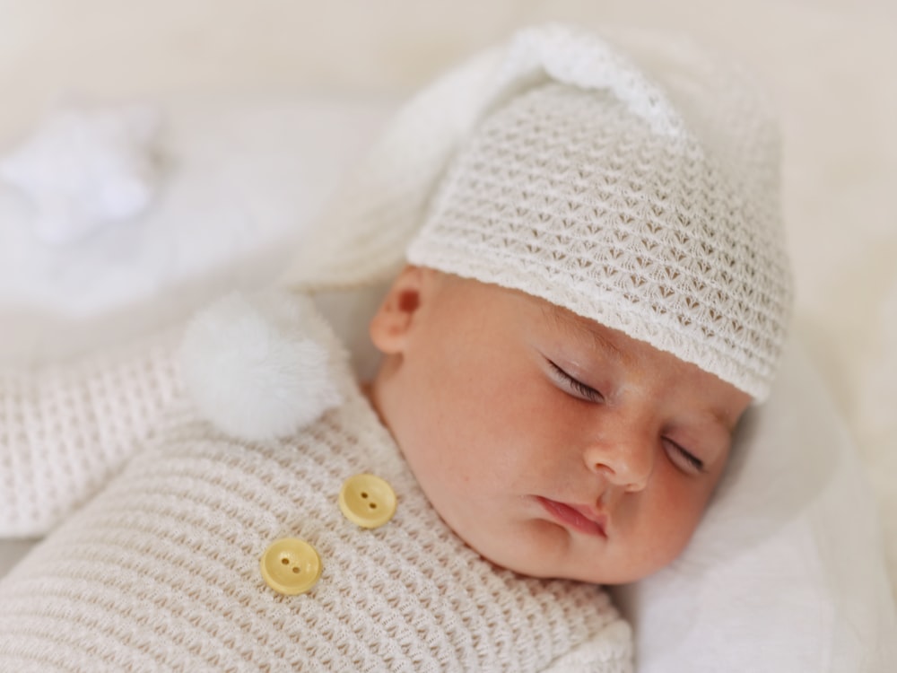 a baby wearing a white hat