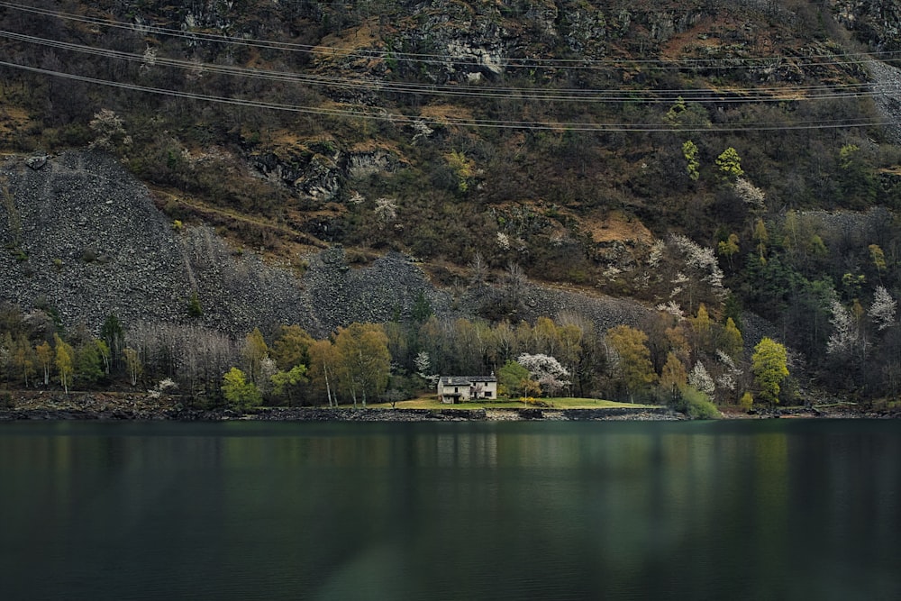 a house on a hill by a lake
