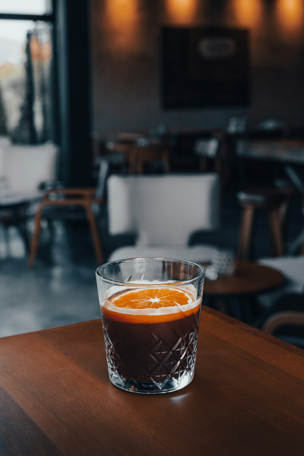 a glass of liquid on a table