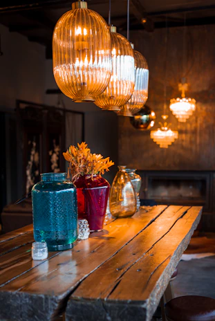 a chandelier over a table with vases of flowers