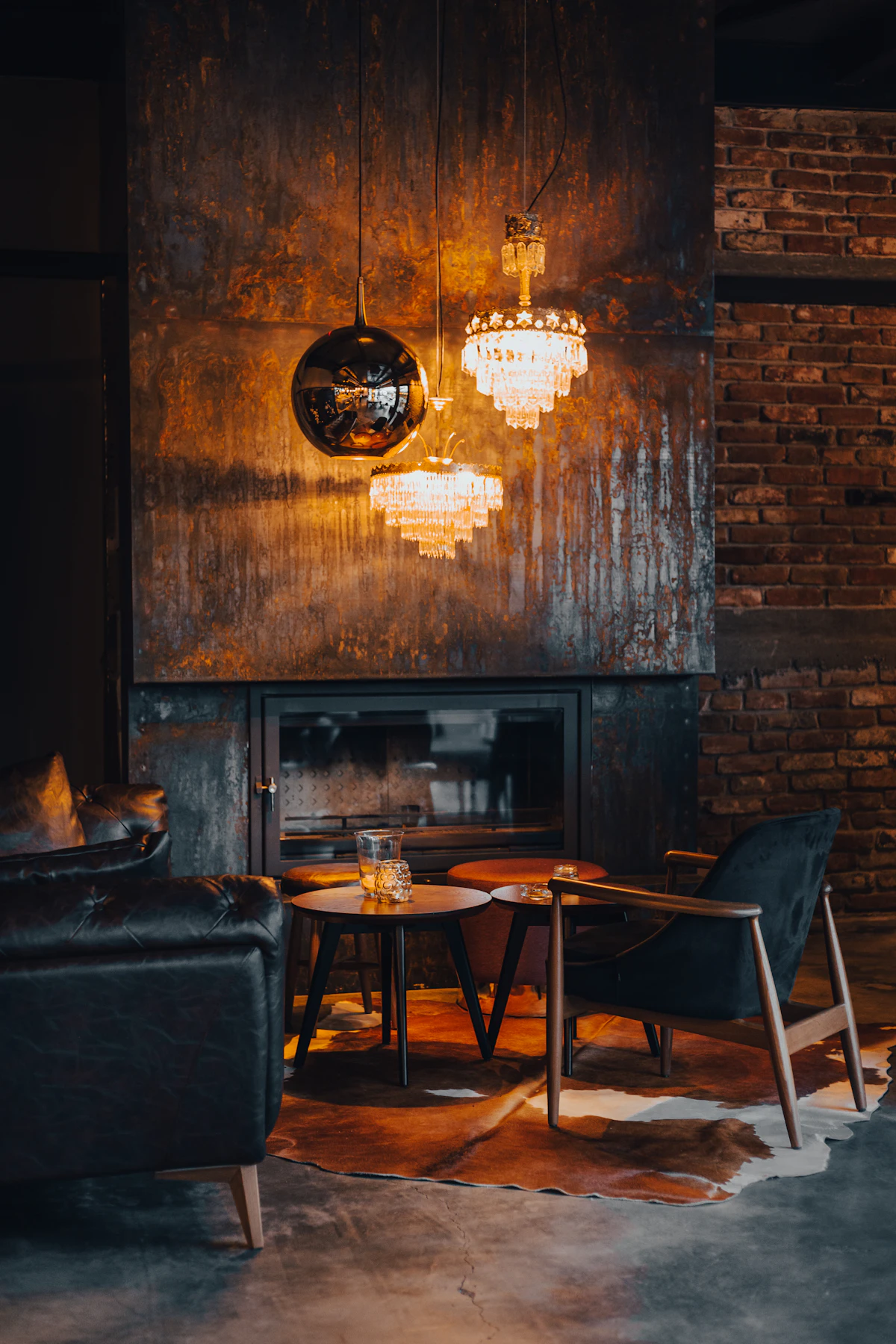 A bare wooden table with two chairs in a spare, softly lit room at Maison Noir.