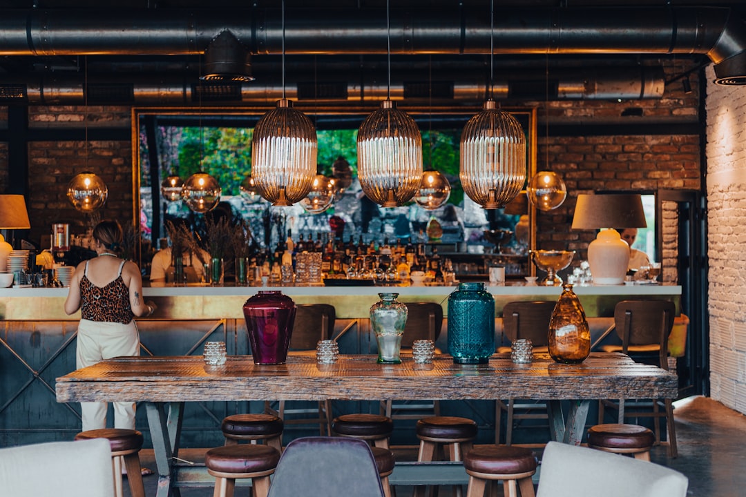 a person standing next to a bar,