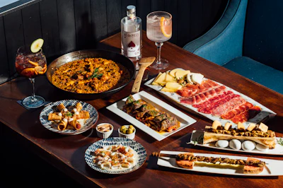 Assortment of small tapas-style plates, representing a Portuguese-Brazilian buteco bar