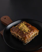 Delicate pieces of nut-filled baklava dusted with powdered sugar
