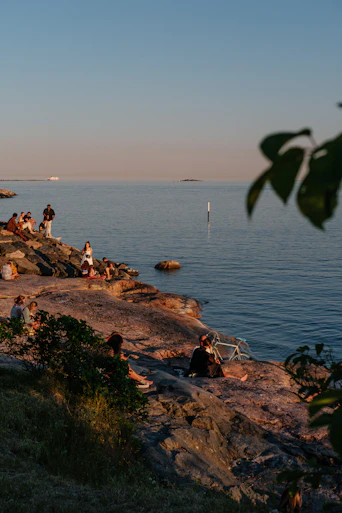 a group of people on a rocky beach