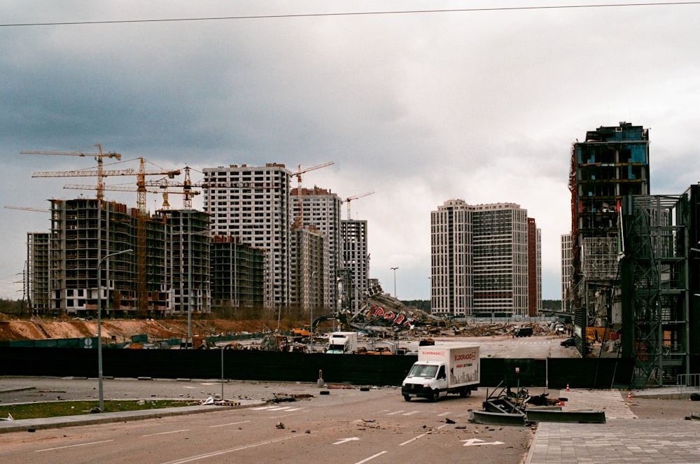 a construction site with cranes and buildings