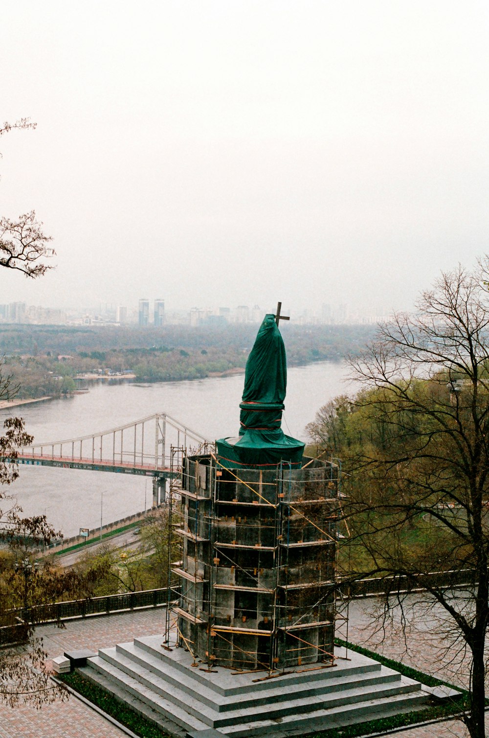 a large green statue on a roof