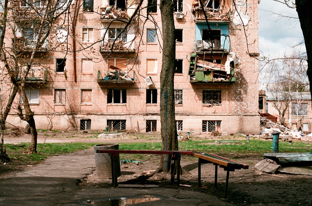 a building with tables and benches in front of it