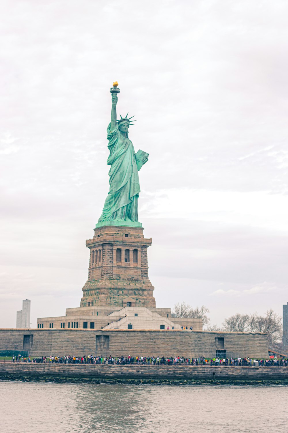 a large statue of a person holding a torch