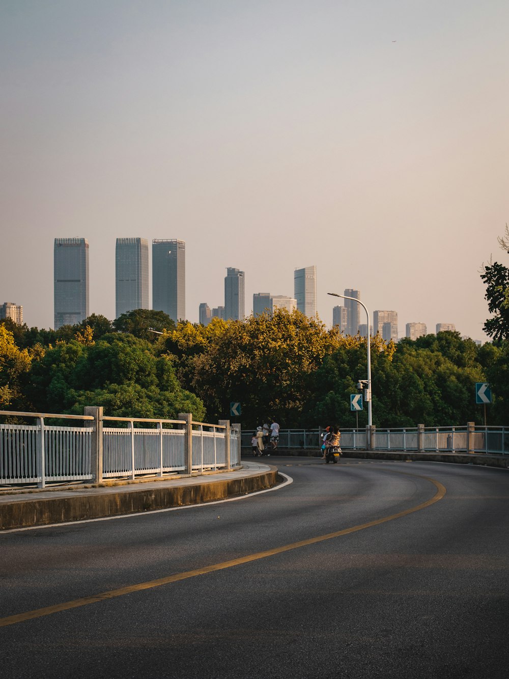 a road with a city in the background