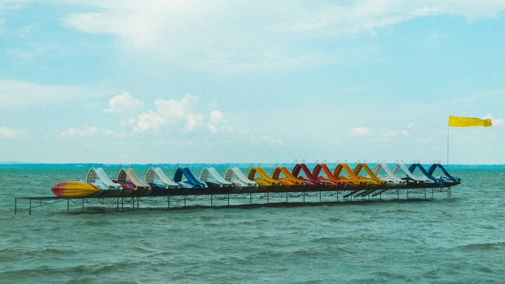 a group of colorful tents on a dock over water