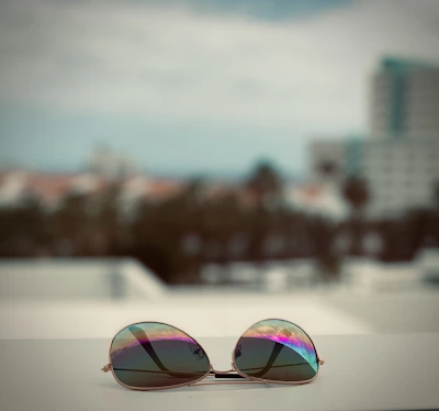 A happy customer trying on sunglasses with a bright cityscape behind.