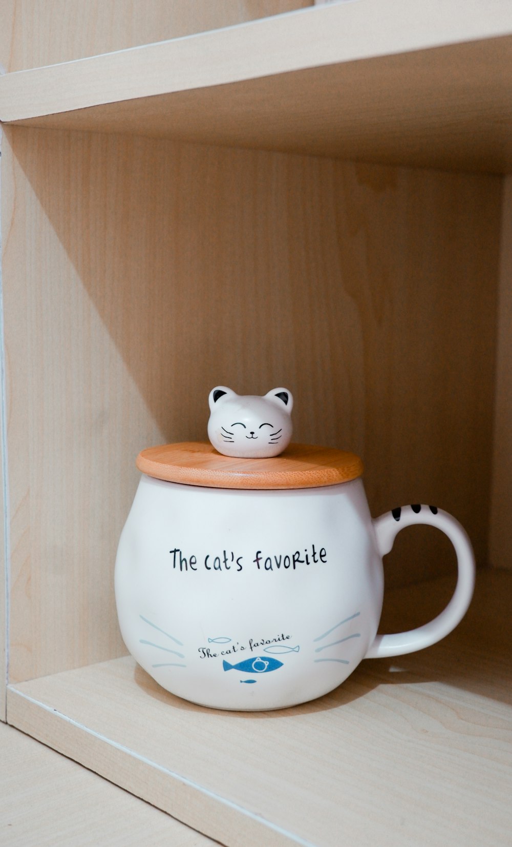 a coffee cup with a cartoon cat on it