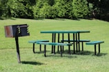 A picturesque BBQ area surrounded by greenery, perfect for family gatherings and outdoor meals.