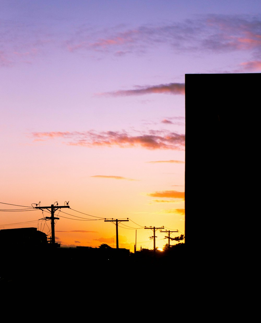 a sunset over power lines