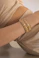 a person wearing a gold bracelet