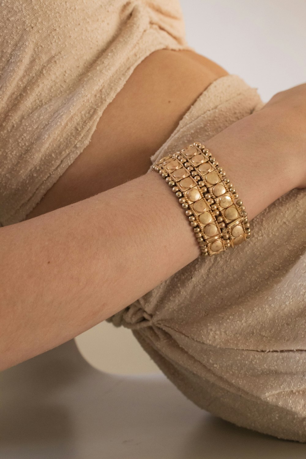a person wearing a gold bracelet