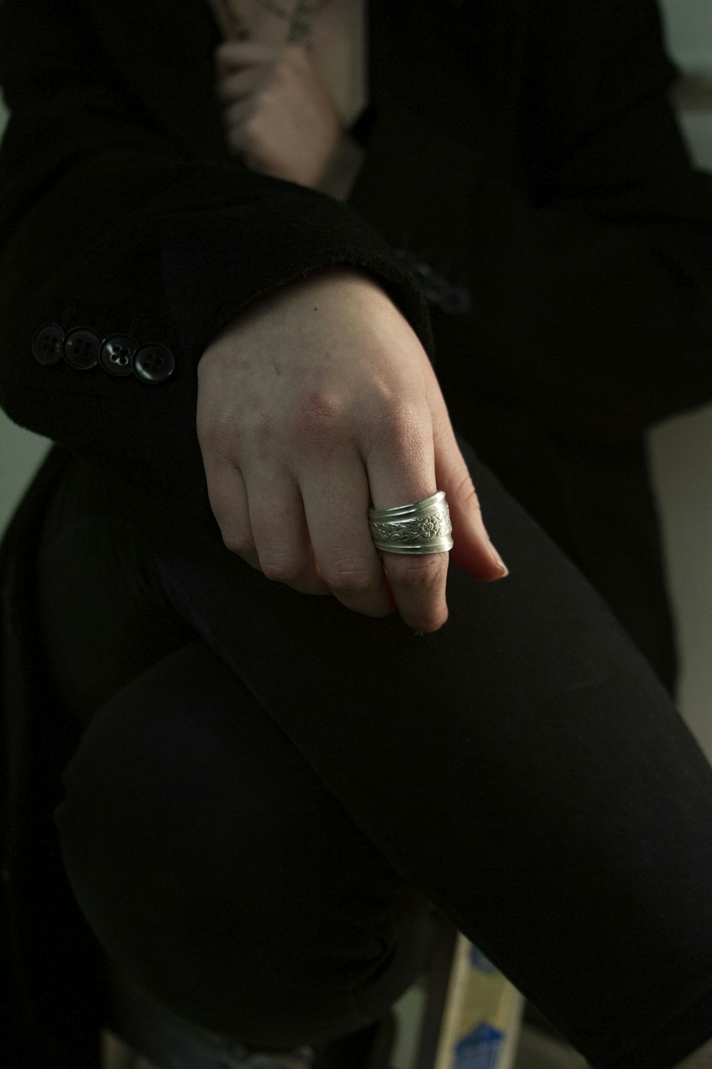 a person's hand with a ring on it