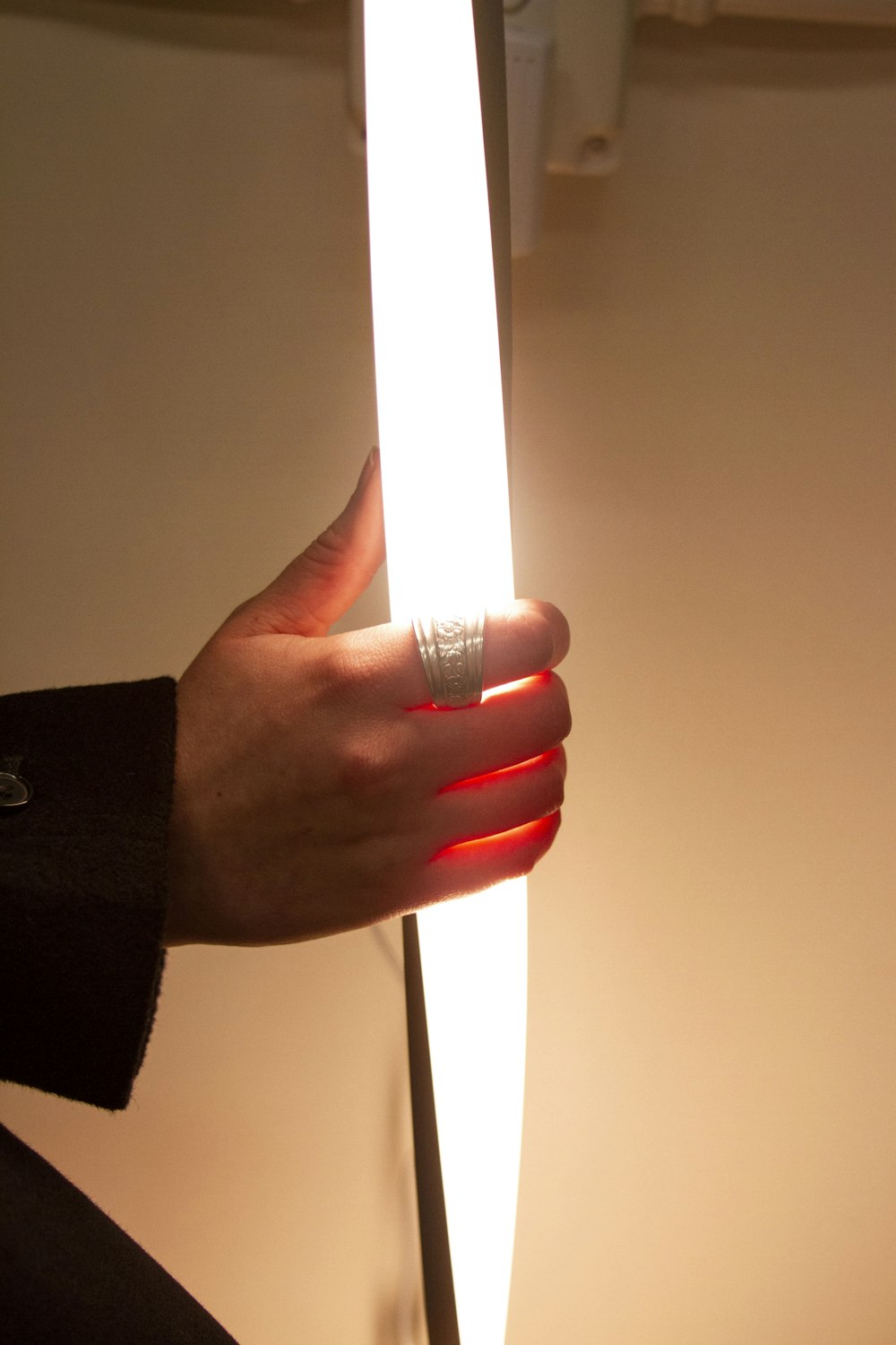 a hand holding a lit up light