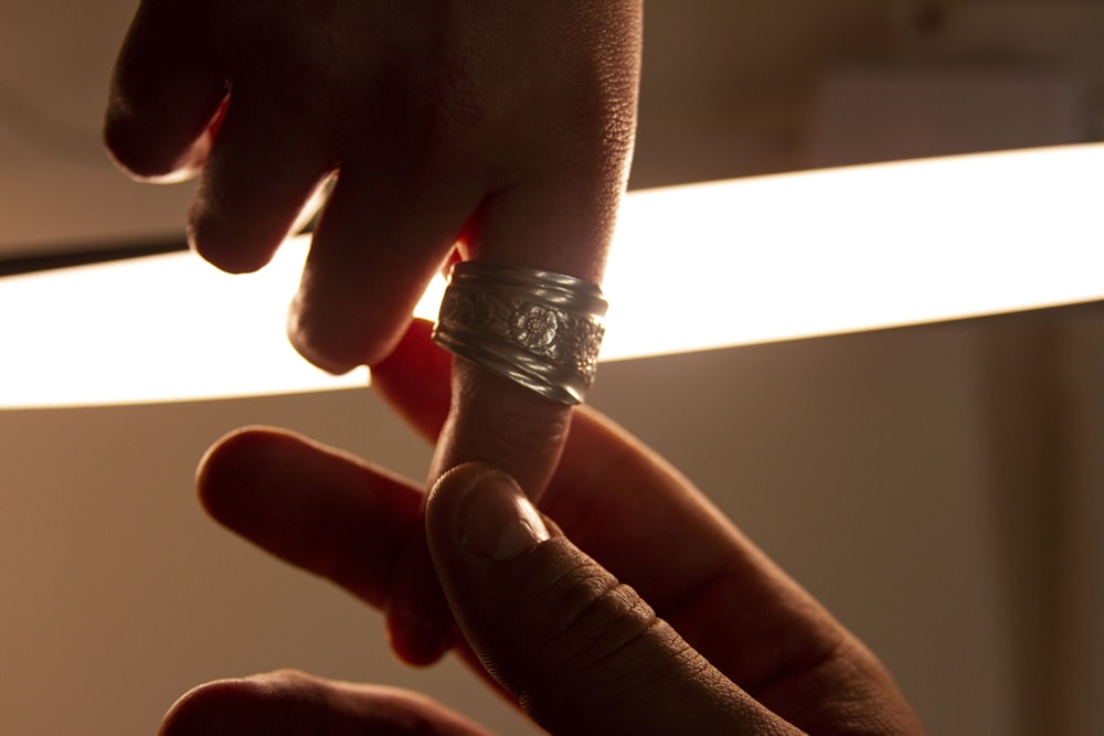 a close-up of a hand holding a light bulb