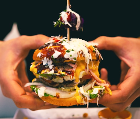 a person holding a burger