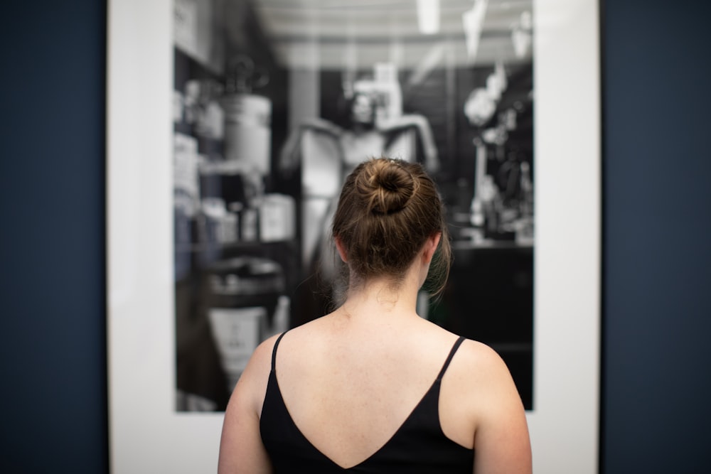 a woman looking at a mirror